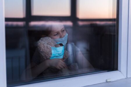 Stay at home quarantine coronavirus pandemic prevention. Sad child and his teddy bear both in&hellip;